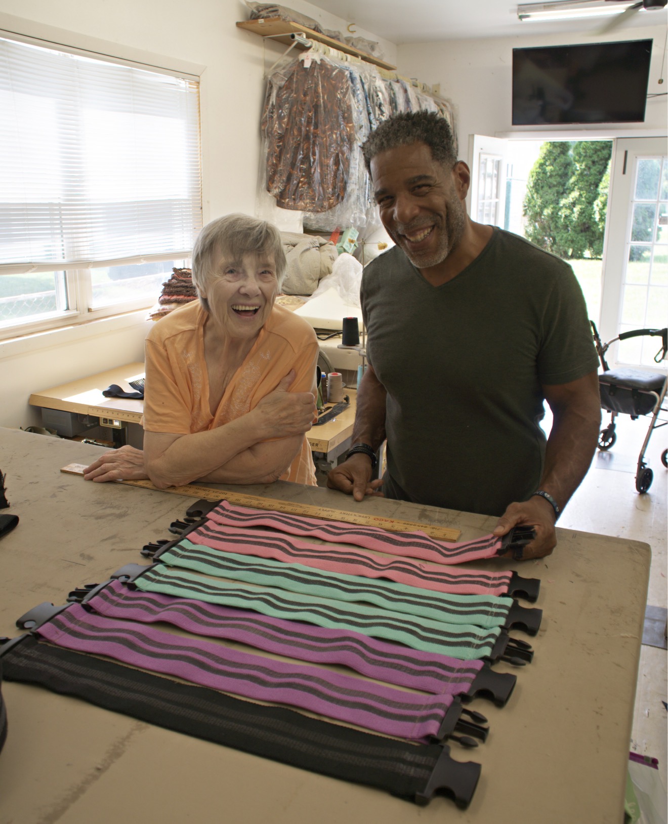 Glutivate founder Tony and seamstress Erika Pasterak beside finished SwiftClick bands in her workshop