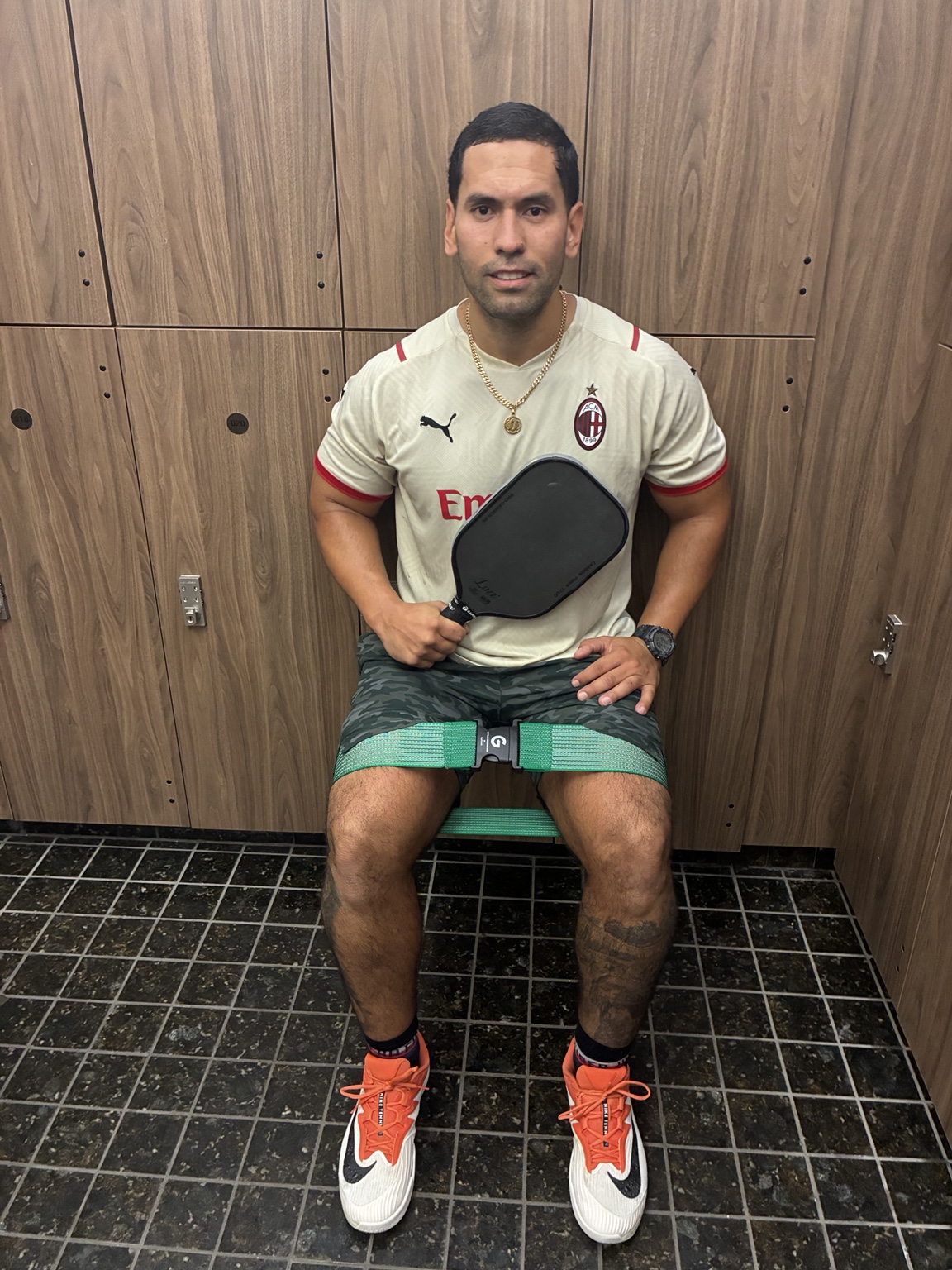 Person with a pickleball paddle wearing a Hunter Green SwiftClick band
